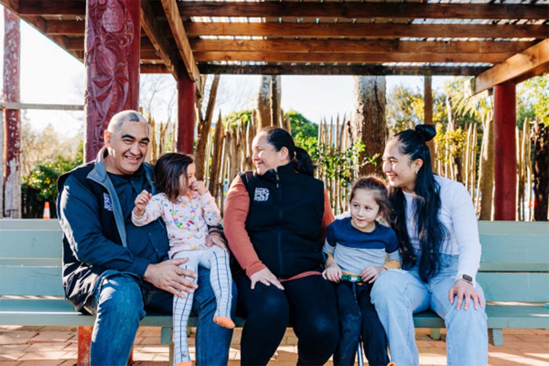 family sitting on bench