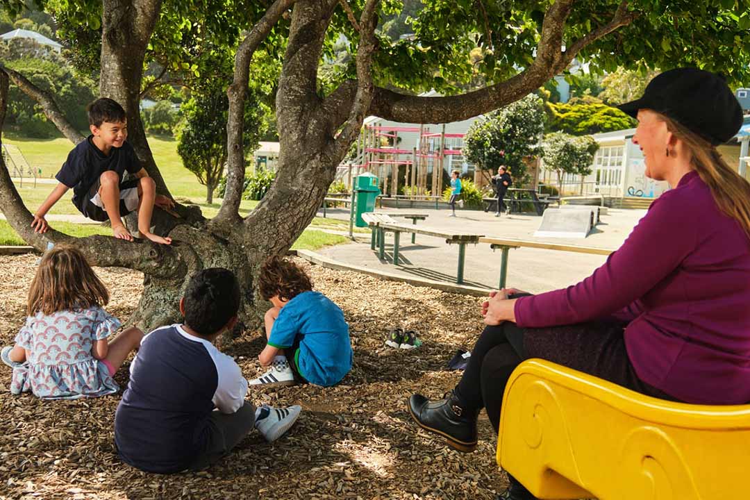 teacher watching students in playground NZ website project